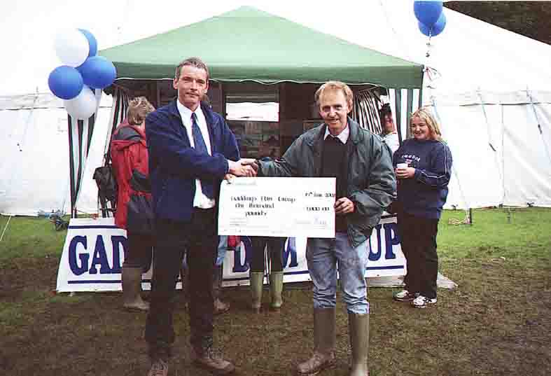 Peter Rigg presents a cheque for £1,000 to the Gaddings Dam Group